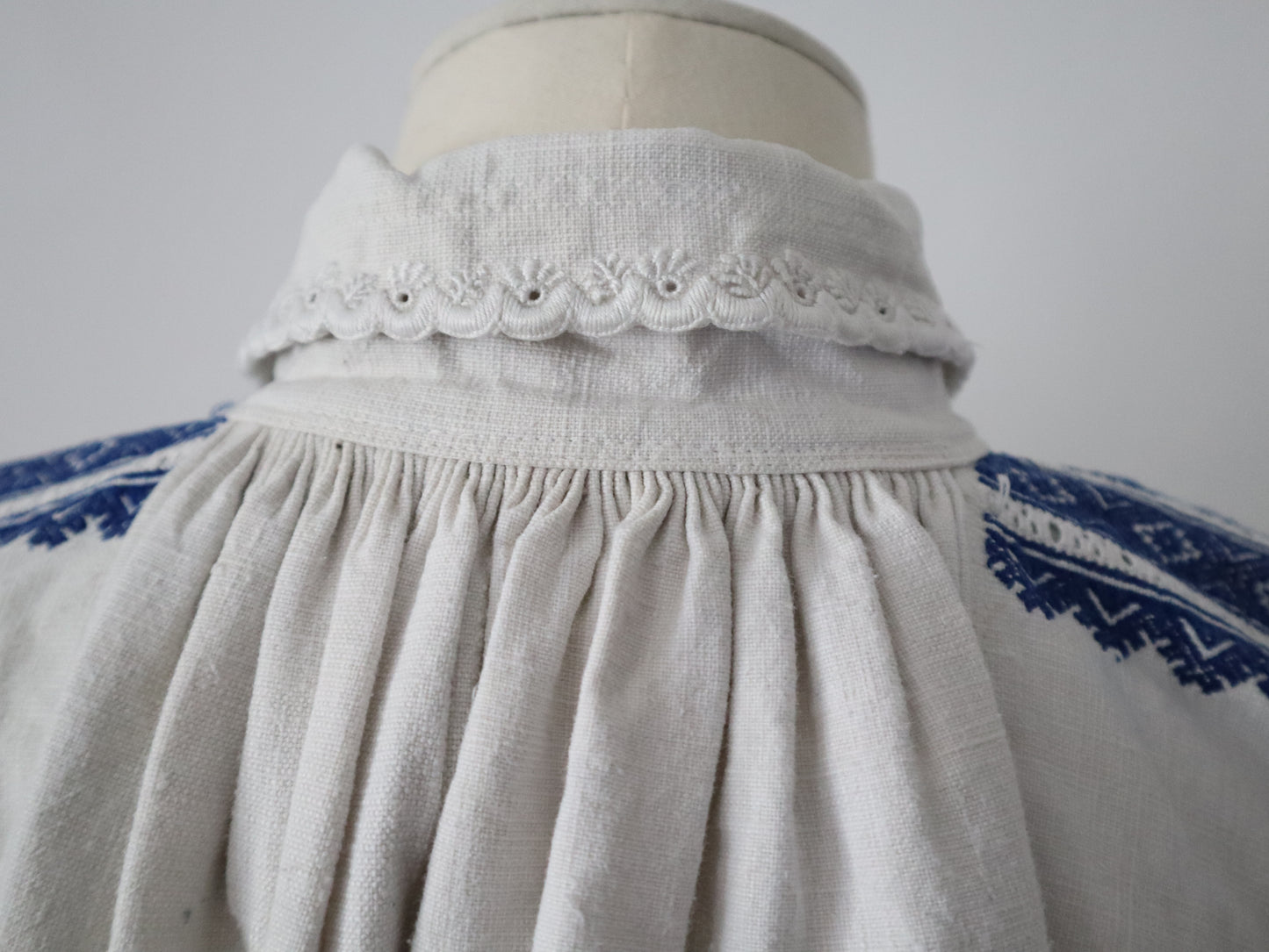 1930s Transylvanian homespun linen folk blouse blue embroidery cutwork floral details blue glass buttons menswear