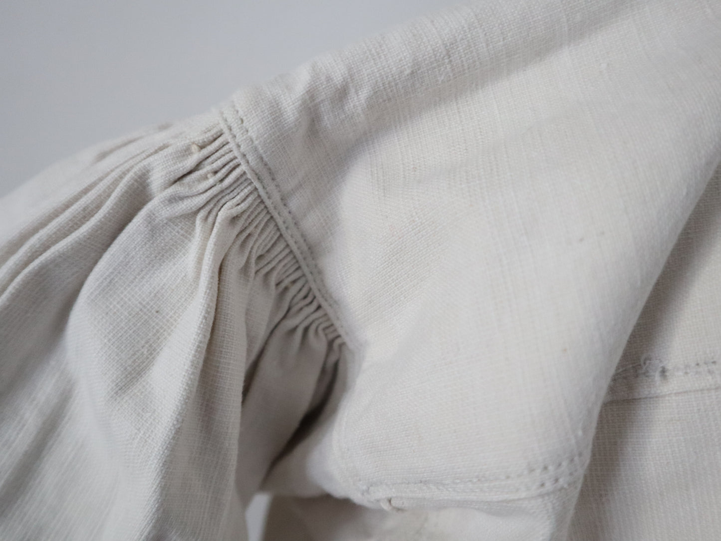 1930s Transylvanian homespun linen folk blouse cutwork embroidery red and blue pressed glass buttons menswear