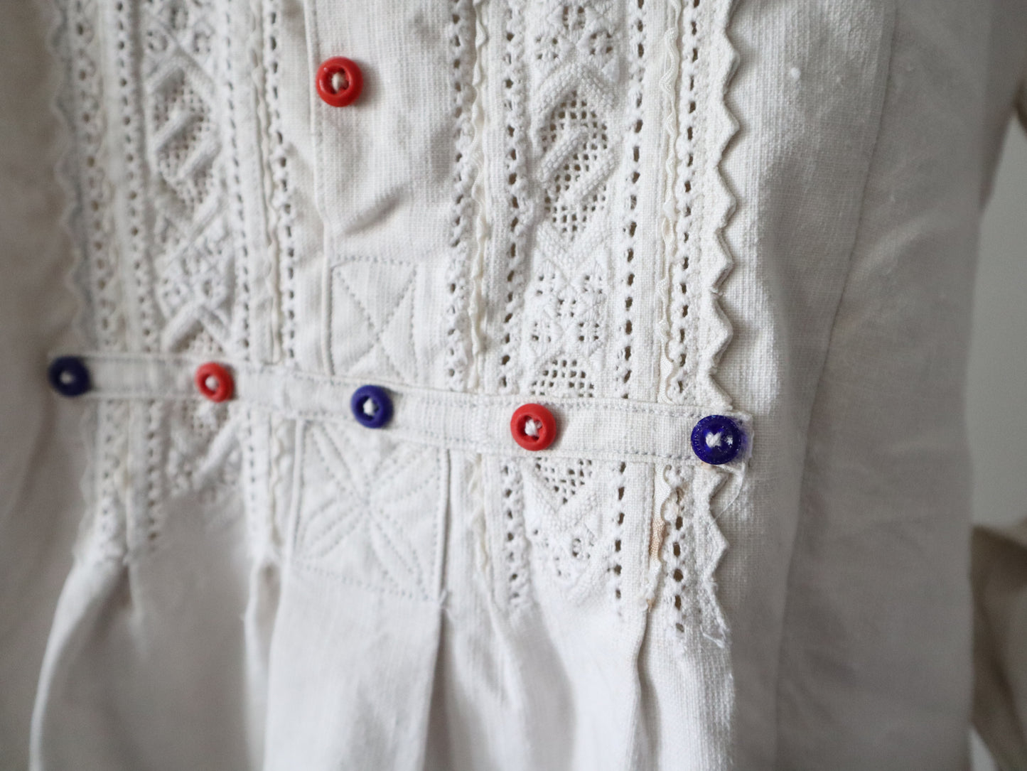 1930s Transylvanian homespun linen folk blouse cutwork embroidery red and blue pressed glass buttons menswear