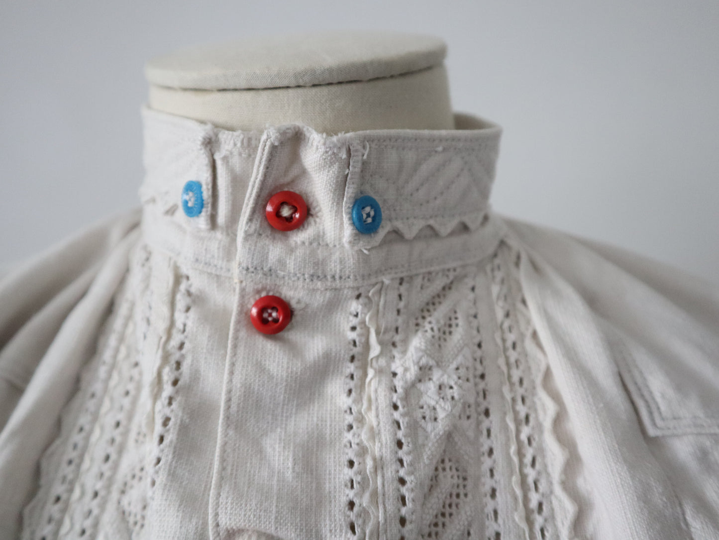 1930s Transylvanian homespun linen folk blouse cutwork embroidery red and blue pressed glass buttons menswear