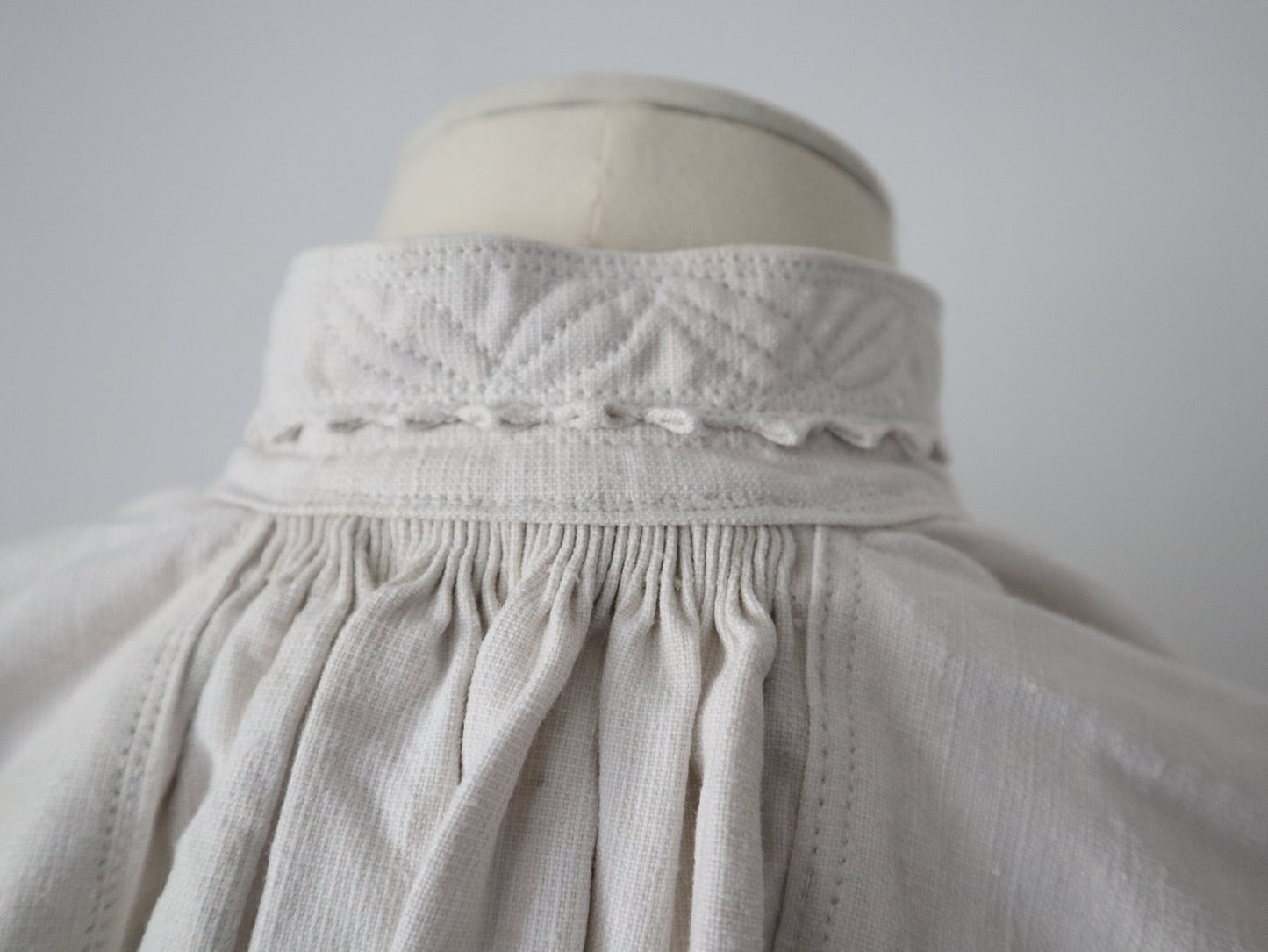 1930s Transylvanian homespun linen folk blouse cutwork embroidery red and blue pressed glass buttons menswear