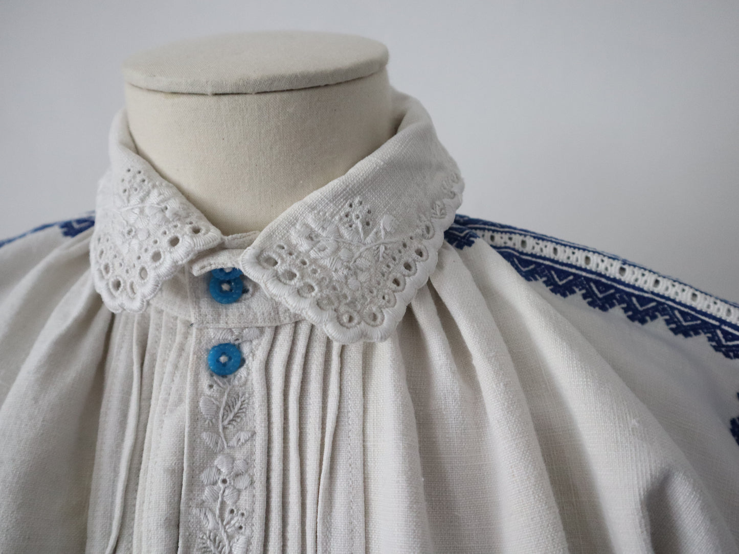 1930s Transylvanian homespun linen folk blouse blue embroidery cutwork floral details blue glass buttons menswear